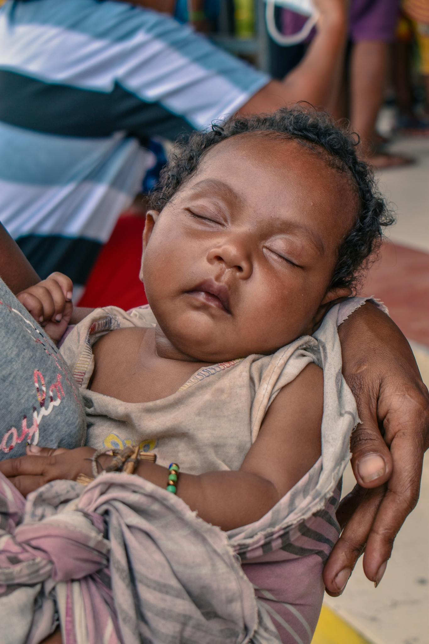 A peaceful baby sleeping in an indigenous mother's arms in Floridablanca.